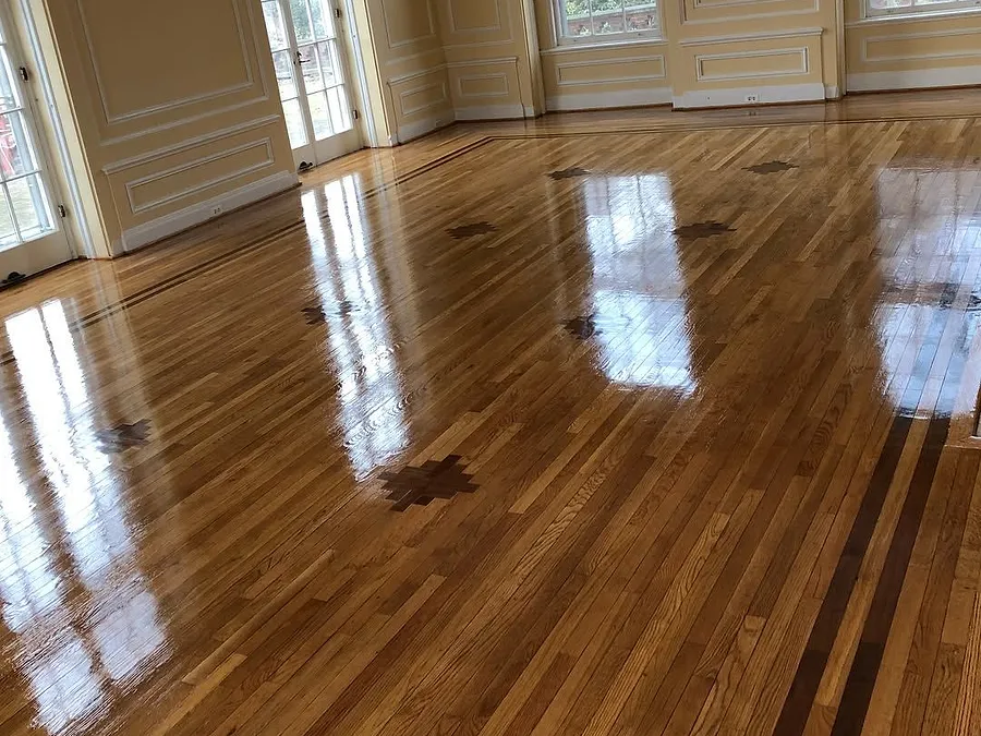 Large formal room with a glossy hardwood floor and a contrasting border