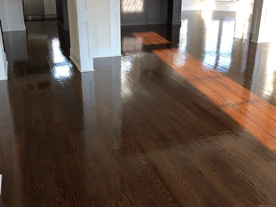 Open kitchen with a dark, glossy refinished hardwood floor