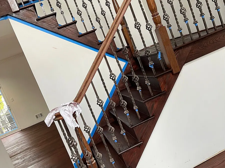 Staircase with dark hardwood treads and iron balusters